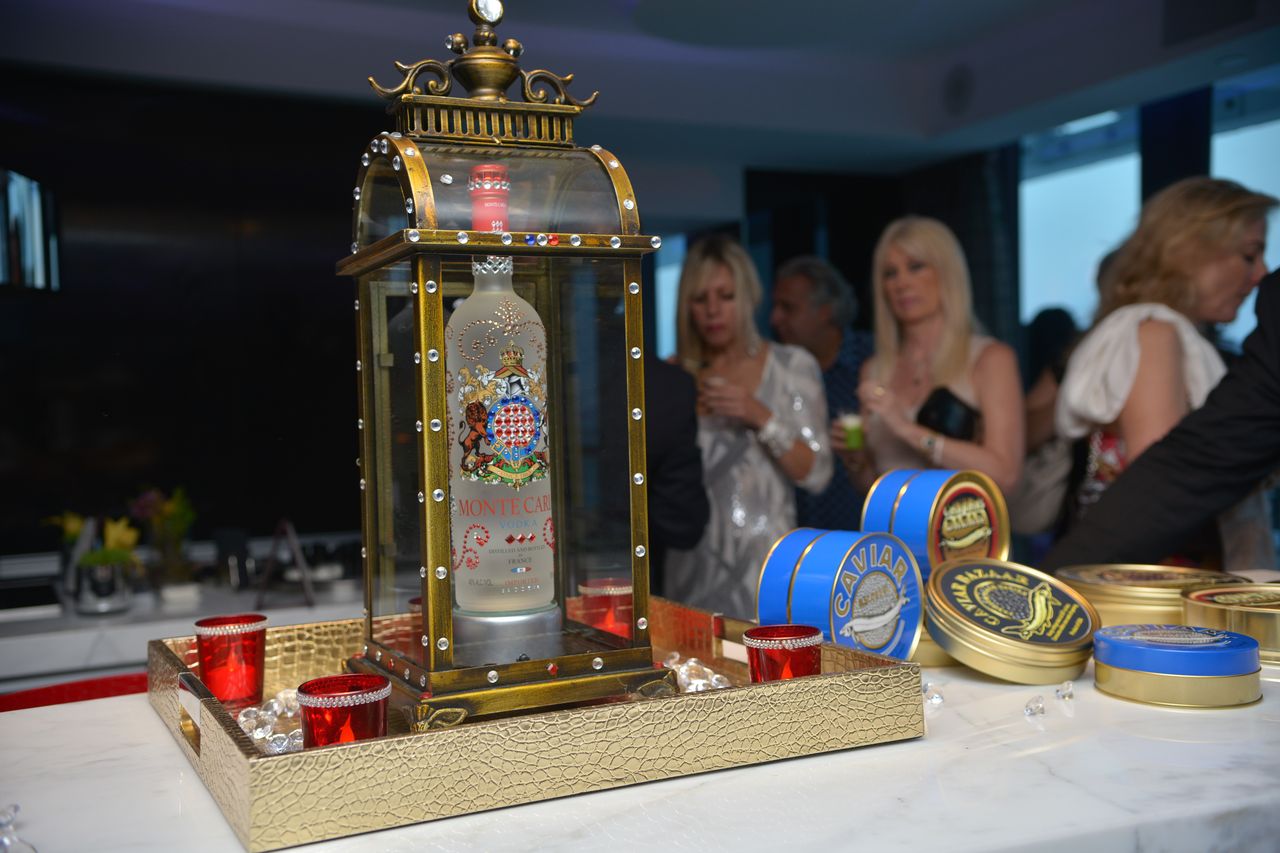 Tins of caviar and a lantern-shaped vodka bottle at the Le CITY deluxe Miami Anniversary Event.